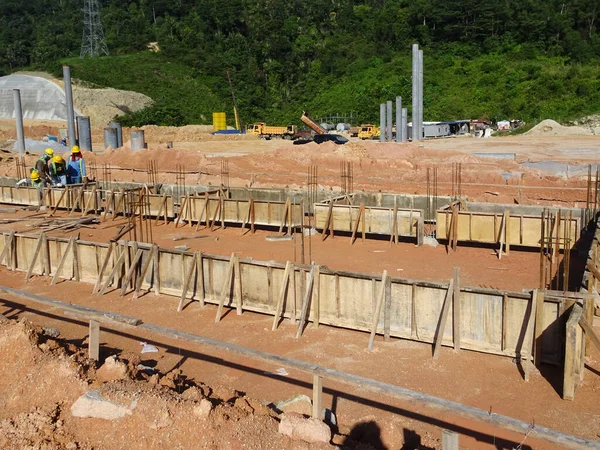 Building ground beam under construction using temporary timber plywood at the site. Reinforced by the reinforcement steel to strengthen the structure.