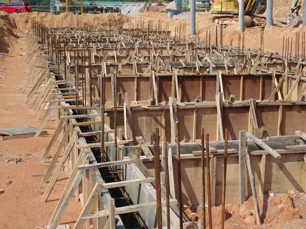 Building ground beam under construction using temporary timber plywood at the site. Reinforced by the reinforcement steel to strengthen the structure.   