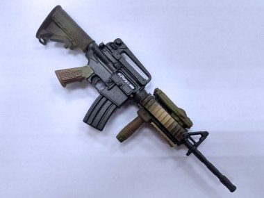 KUALA LUMPUR, MALAYSIA -JUNE 09, 2018: Plastic model of military automatic gun in small scale. Sale as a collector item for military gear collector and hobbyist.  clipart