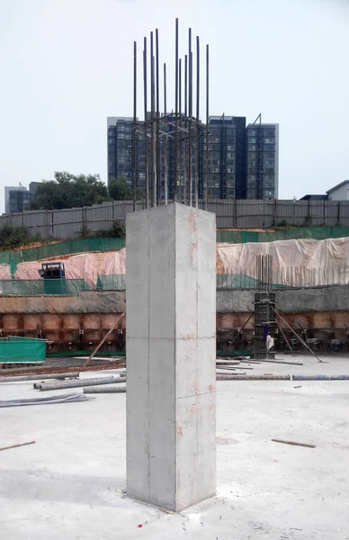 Steel reinforced concrete column under construction. It is as part of building structure at the construction site. Reinforcement bar on top of column ready for the next stage of construction.