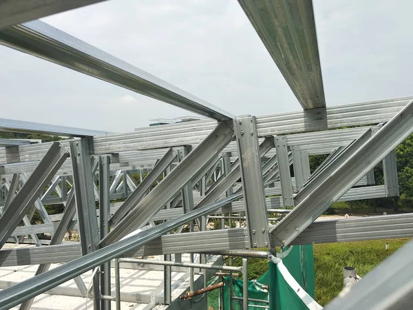 stock image KUALA LUMPUR, MALAYSIA -JUNE 16, 2019: Lightweight roof trusses under construction at the construction site. Installed properly by workers to received the roof covering system. 