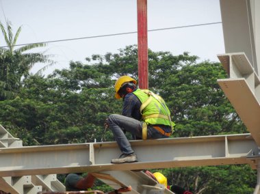 Kuala Lumpur, Malezya - 12 Ocak 2020: Çelik yapının inşaatında çalışan inşaat işçileri. Çelik yapı, bina için büyük ve uzun bir süre sağlayabilir..