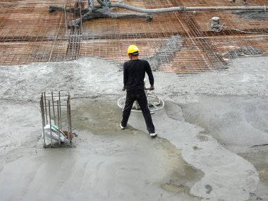 KUALA LUMPUR, MALAYSIA -JULY 16, 2017: Power float works by construction workers at the construction site. The power float machine was used to level wet concrete. 