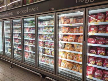 KUALA LUMPUR, MALAYSIA -JULY 17, 2019: Frozen foods displayed on the rack inside the large chiller in the supermarket. Displayed and arranged by the brand to make easy for the customer to select. 