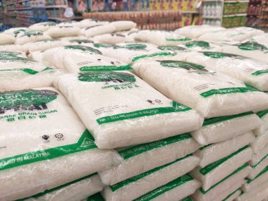 KUALA LUMPUR, MALAYSIA - JULY 24, 2019: White sugar or table sugar packed in transparent plastic packaging and displayed in the supermarket for sale. Stacked by brands for the customer to choose.