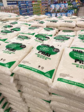 KUALA LUMPUR, MALAYSIA - JULY 24, 2019: White sugar or table sugar packed in transparent plastic packaging and displayed in the supermarket for sale. Stacked by brands for the customer to choose.