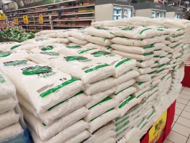 KUALA LUMPUR, MALAYSIA - JULY 24, 2019: White sugar or table sugar packed in transparent plastic packaging and displayed in the supermarket for sale. Stacked by brands for the customer to choose.