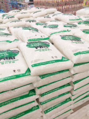 KUALA LUMPUR, MALAYSIA - JULY 24, 2019: White sugar or table sugar packed in transparent plastic packaging and displayed in the supermarket for sale. Stacked by brands for the customer to choose.