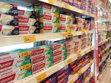 KUALA LUMPUR, MALAYSIA -DECEMBER 09, 2019: The toothpaste is in the box and is displayed on the shelf sorted by brand and type. This makes it easy for buyers to choose from. clipart
