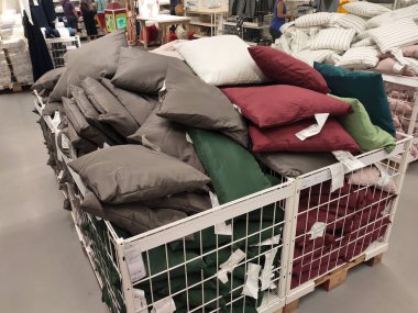 SEREMBAN, MALAYSIA -MARCH 16, 2020: Selected focused of pillows and cushion covers of various colors are on sale. Some of them were hung in size and some were put in large metal boxes.