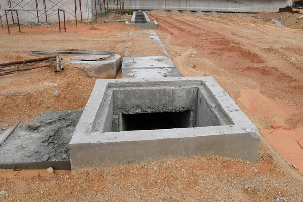 Utility services manhole under construction at the construction site. In-situ construction by workers based on infrastructure engineer design.