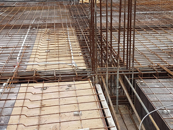 KUALA LUMPUR, MALAYSIA -MARCH 3, 2020: Building floor slab under construction. Construction workers fabricating the timber formwork and installing the steel reinforcement bar. 