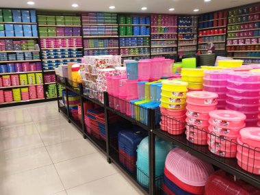 Small plastic containers for sale inside the supermarket. It comes in a variety of sizes,  design and colours to meet its purpose.  clipart