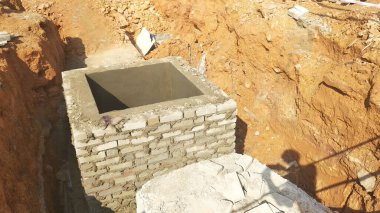 İnşaat alanında inşaat halindeki rögar kapağı. Altyapı mühendisi tasarımına dayanan işçilerin In-situ inşaatı.