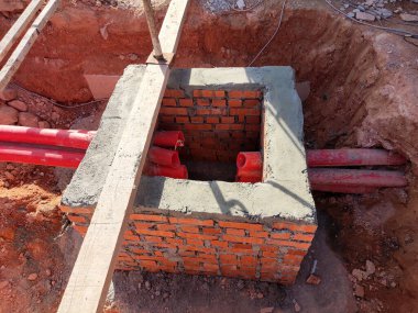 İnşaat alanında inşaat halindeki rögar kapağı. Altyapı mühendisi tasarımına dayanan işçilerin In-situ inşaatı.