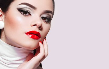 Beautiful young girl with smooth skin in retro style on a white background.Fashion, beauty, cosmetics, make-up, make-up artist, beauty salon business, sales, advertising.
