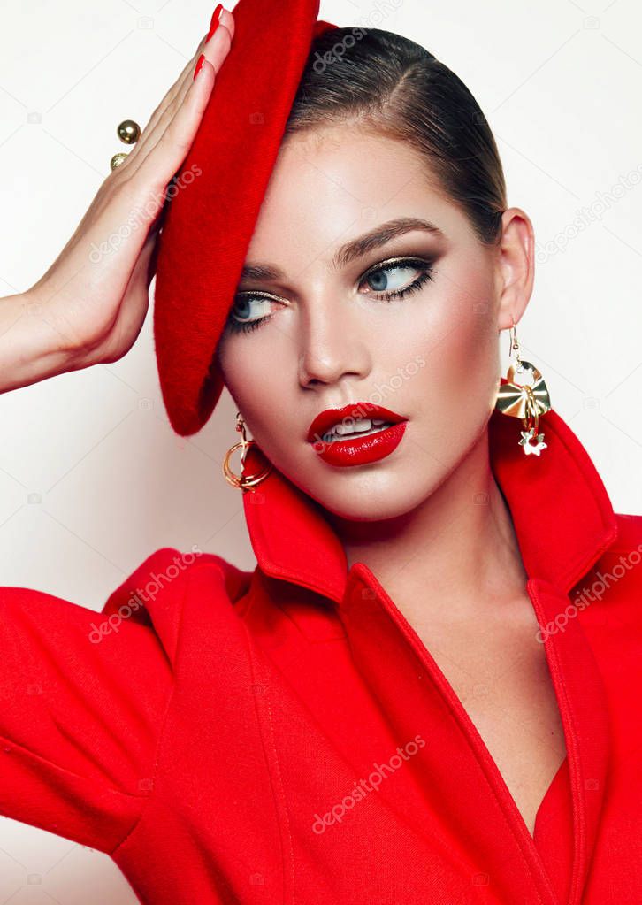 Beautiful young girl in a red jacket, jacket and red beret. Frenchwoman, style. Outerwear, headwear. Girl in retro style. Red lipstick.