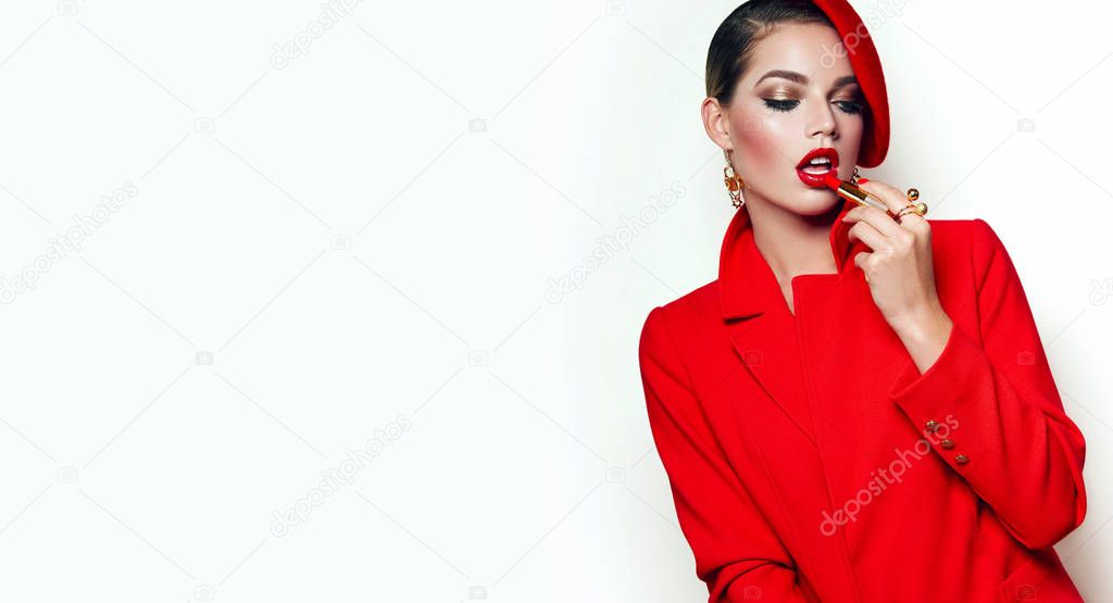 Beautiful young girl in a red jacket, jacket and red beret. Frenchwoman, style. Outerwear, headwear. Girl in retro style. Red lipstick.
