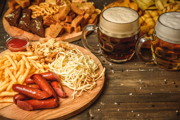 snacks to beer on wooden background top view