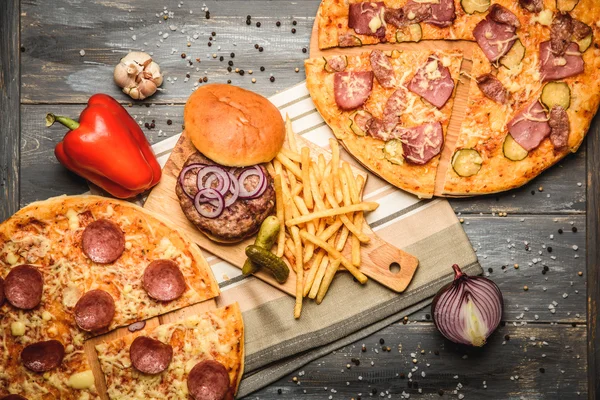 Pizza ve hamburger ahşap arka plan üzerinde