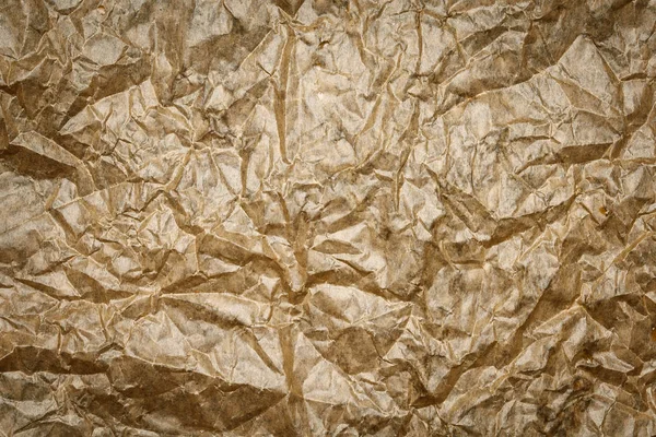 Old crumpled parchment texture. Beige paper sheet background, wrinkle, burnt.