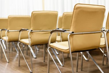 satır boş bir odada toplantısında metal sandalye. Arkadan Görünüm