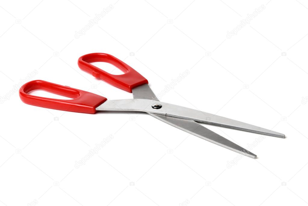 Red scissors on isolated white background close up