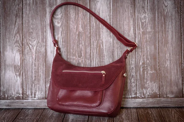 Red leather bag on brown wooden background. — Stock Photo, Image