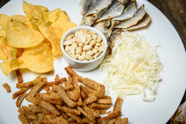 Beer snacks on wooden background served in the restaurant — Stock Photo, Image