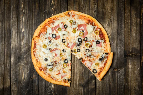 Top view of Italian rustic PIZZA on wooden table background — Stock Photo, Image