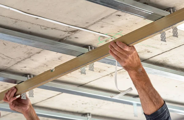 Los constructores instalan el perfil del techo en el nuevo apartamento . — Foto de Stock
