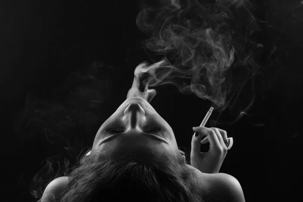 Young girl in the smoke with cigarette — Stock Photo, Image