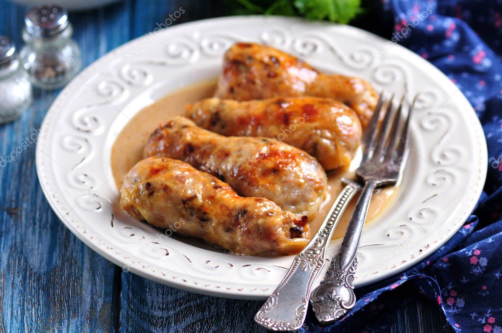 Baked chicken drumsticks stuffed with fried mushrooms and cheese in a creamy sauce.