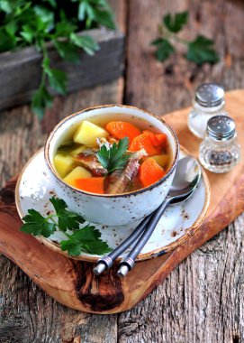 Balık patates, havuç ve eski ahşap zemin üzerine maydanoz çorbası.