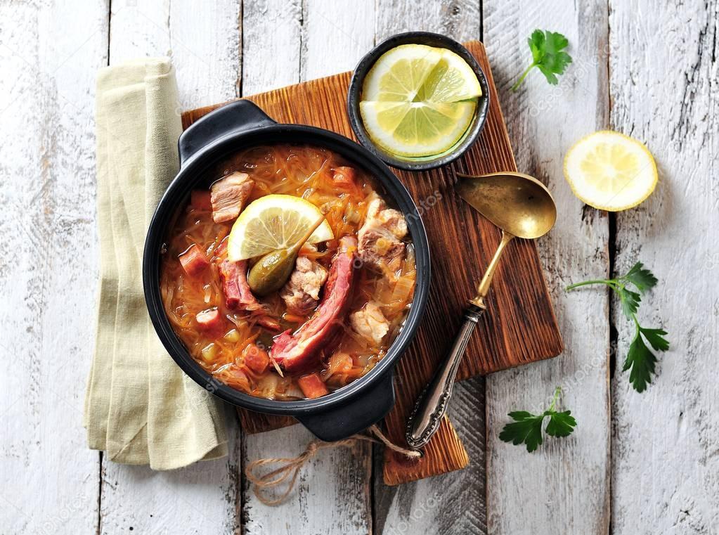 Traditional thick soup made from sauerkraut with pork, smoked pork ribs, sausages, capers and lemon.