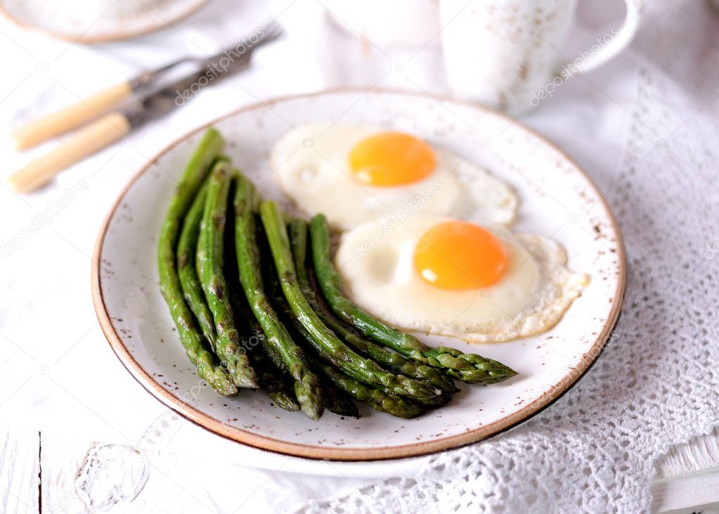 Fried asparagus with eggs. Healthy breakfast.