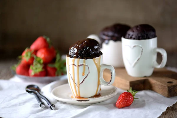 Delicious Chocolate cake cooked in a microwave in a mug with caramel syrup.