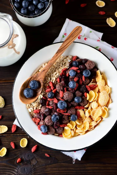 Mısır gevreği, çikolata topları, yulaf ezmesi, goji meyveleri ve taze yaban mersini sağlıklı kahvaltı.