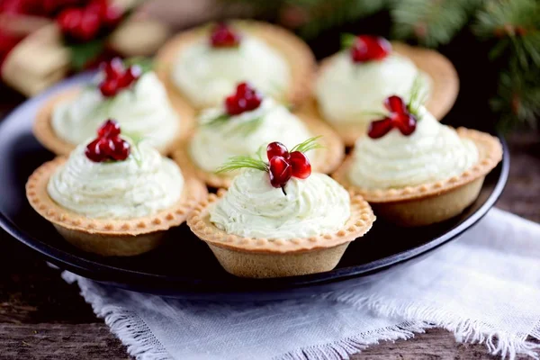 Tartlets with avocado pasta, cottage cheese, fish caviar and pomegranate.
