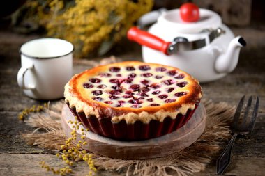 Eski bir ahşap zemin üzerine kiraz ile ev yapımı peynirli kek. Rustik tarzı.