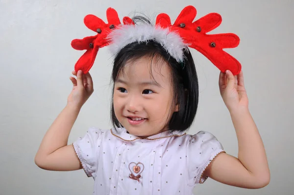 Asiático menina vestindo um rena headband — Fotografia de Stock