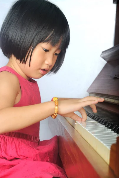 Pequeño asiático niño jugando el piano — Foto de Stock