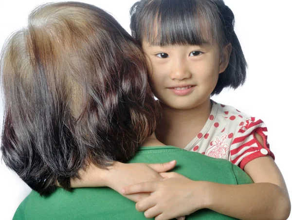 Little asian granddaughter smiling in senior woman's arm — Stock Photo, Image