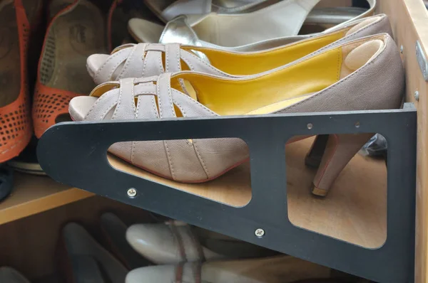 Zapatos en un armario de almacenamiento de madera —  Fotos de Stock