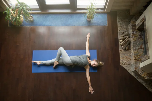 Yoga at home: Revolved Abdomen Pose — Stock Photo, Image