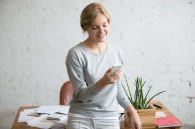Onun elinde bir telefon ile Resepsiyon yakın duran bir öğrenci kız portresi