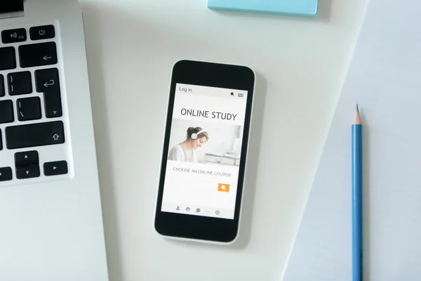 White desk with a mobile phone with title online study