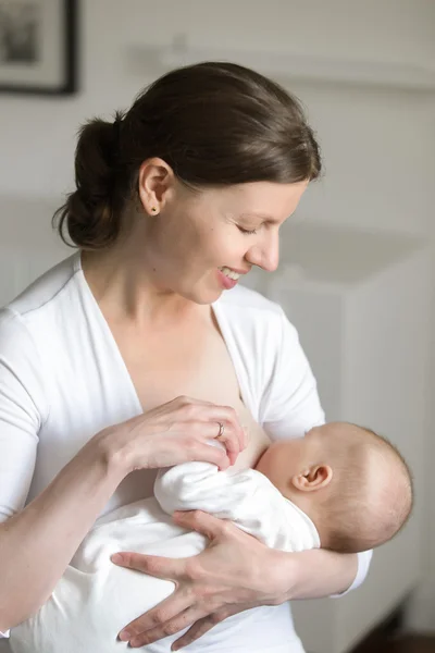 Portrait of a woman breastfeeding a child, on her hands — Stock Photo, Image