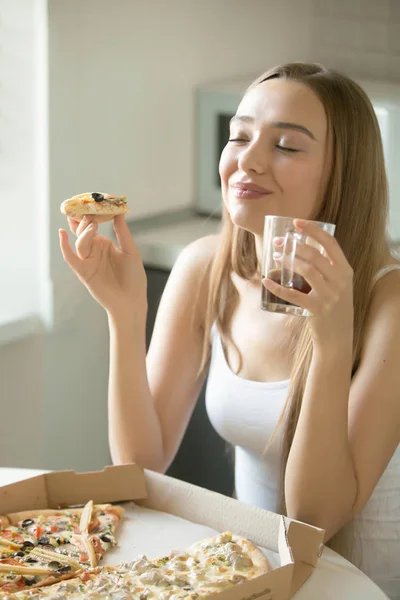 Portret van een jonge vrouw met pizza in haar hand — Stockfoto