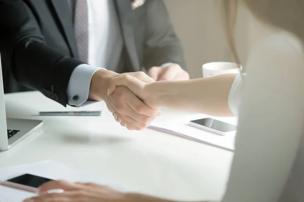 Closeup of male and female hands handshaking after effective neg